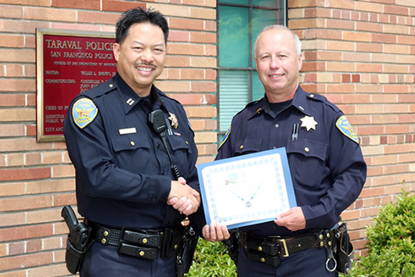 Captain Curtis Lum congratulates Lieutenant Michael Cleary of Taraval on his last day on the job on Tuesday, May 20, 2014. After serving nearly 30 years, Lieutenant Cleary hung up his uniform for the proverbial 'greener pastures.'